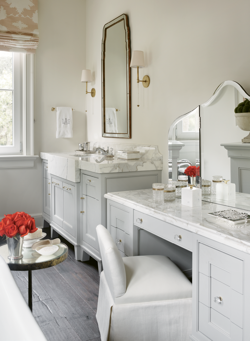 The suite is outfitted with his-and-her baths; Leah’s includes a dressing table complete with a custom vanity stool.