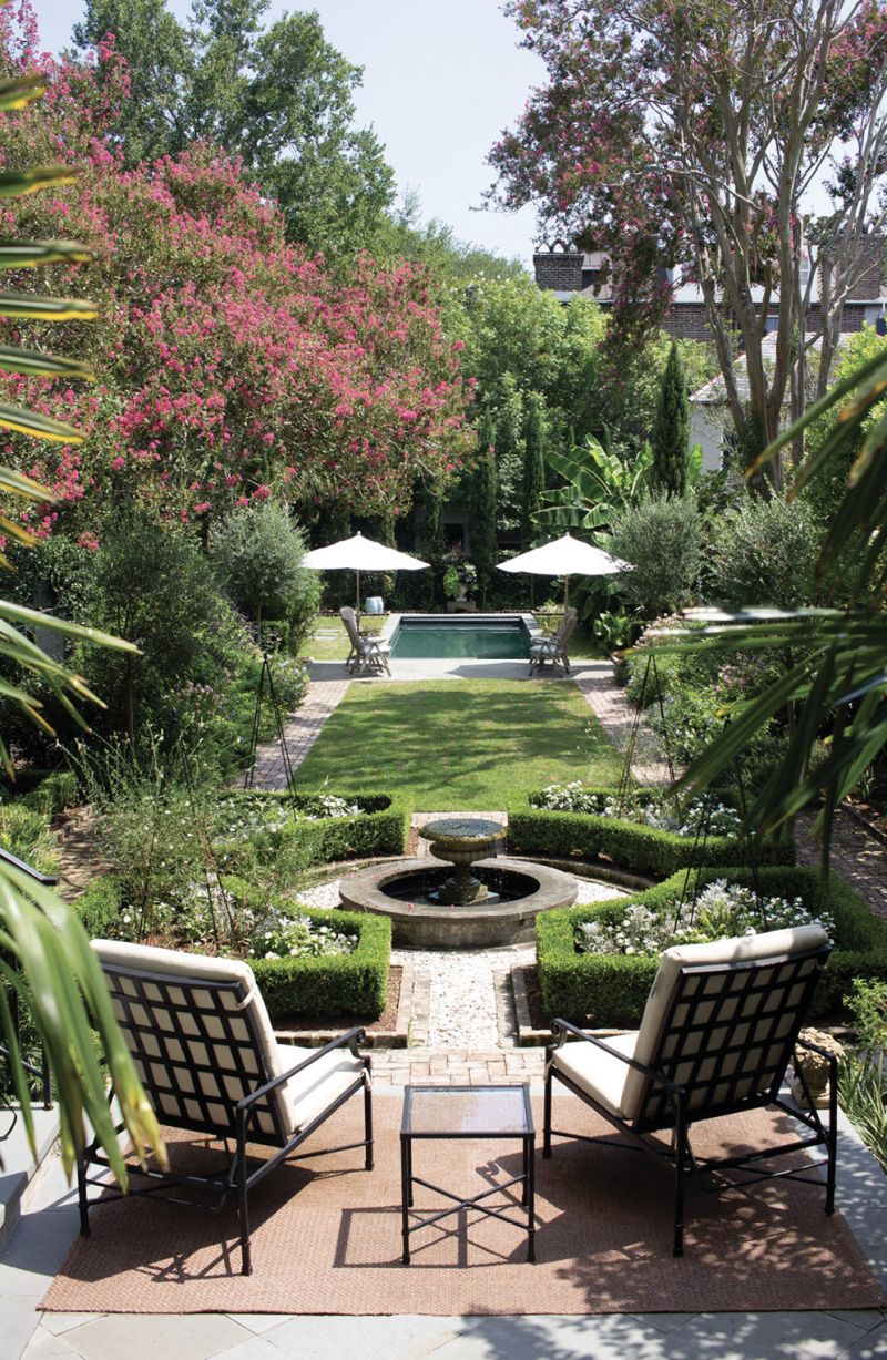A Grand Tour - Landscape architect Sheila Wertimer transformed an elongated backyard into three unique spaces to invoke memories of the homeowners’ favorite destinations. A bluestone patio steps down into a French parterre, followed by English-style beds erupting with blooms on either side of a lush lawn. The pool stretches through the final room—an ode to the Mediterranean.  Location: Downtown, South of Broad (1839, owned by Susan and Gene Massamillo) Issue: April 2019, “Making  Their Getaway” Photographer: Sarah Westmoreland