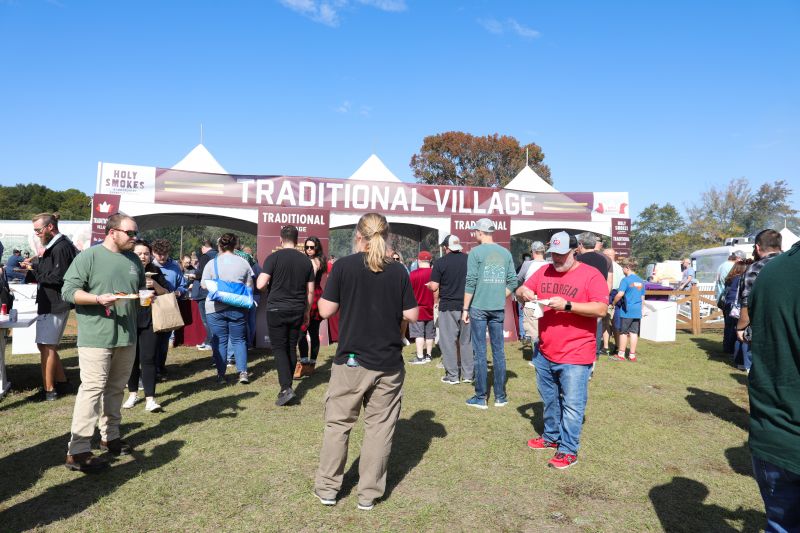 Guests queue up at the Traditional Village for bites from participating chefs, including Carey Bringle of Peg Leg Porker, Anthony DiBernardo of Swig &amp; Swine, and local pitmaster Rodney Scott.