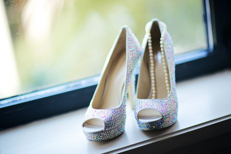 FINAL TOUCHES: For accessories, the bride donned bedazzled peep-toe pumps from Nordstrom and a simple strand of pearls.