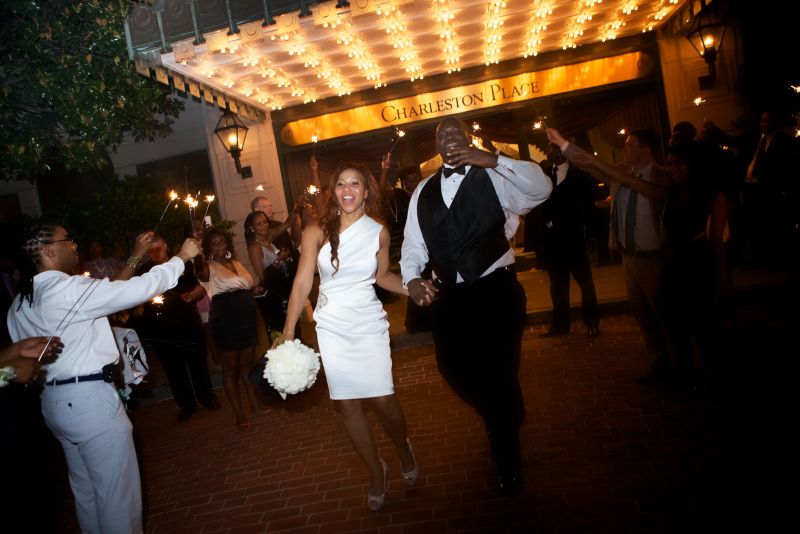 SURROUNDED BY LOVE: Dressed in a little white getaway dress, Richelle and Cedric exit to a tunnel of sparklers. “We are blessed to have each other and to have family, friends and coworkers who love us dearly!” says Richelle.