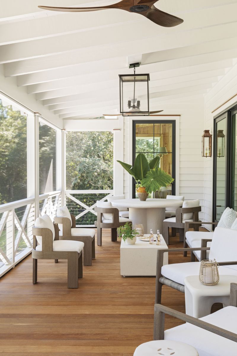 On the screened-in back porch, Restoration Hardware seating and a Burke Decor dining table offer cozy spots to eat, work, and relax. “We spend a lot of time out here,” confirms Jamie, noting, “we’re so thankful we added the screens.”