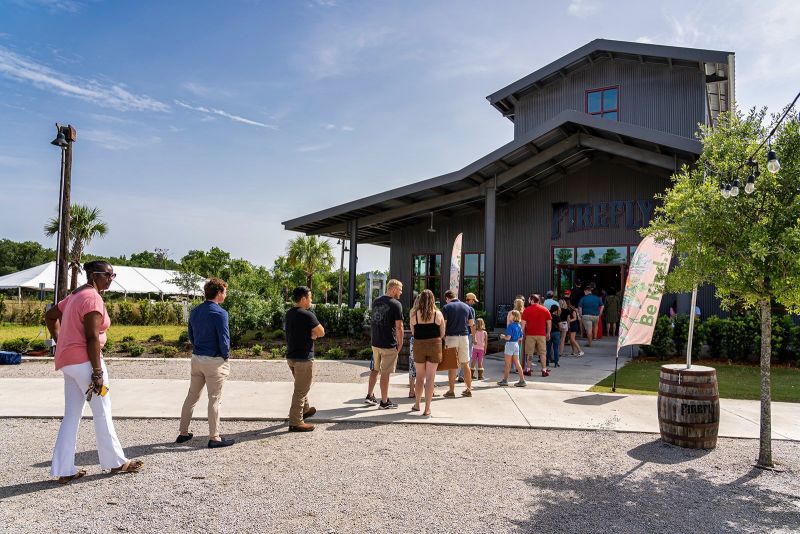 Supporters lined up outside Firefly Distillery for the Chef’s Potluck after a rain shower earlier that day moved the festivities indoors.