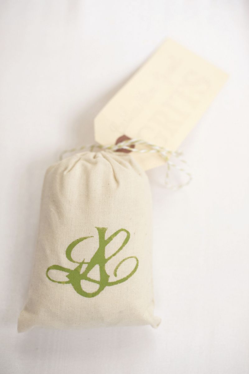 HANDIWORK: Bridesmaid Rosalyn McKoon hand-stenciled the couple&#039;s green monogram on muslin favor bags of grits.