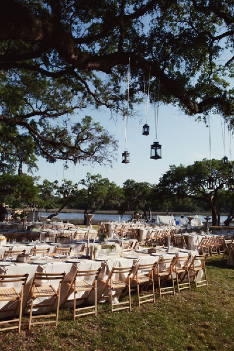 CREEKSIDE CHARM: The marsh, creek, and Wadmalaw Sound in the distance made a picturesque backdrop for the reception dinner underneath the live oaks.