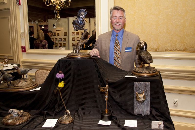 Jim Green posed with his bronze sculptures.