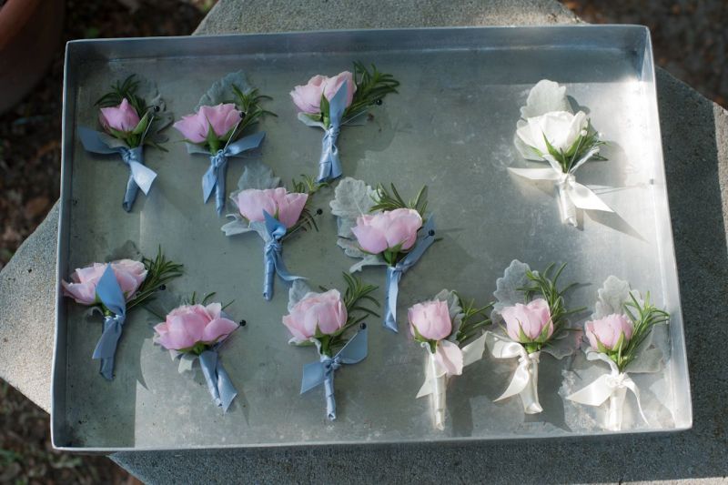 SPRING HUES: Groomsmen wore pink rose boutonnieres accented with rosemary lamb’s ear. Patrick stood out from the bunch with a white rose variation.