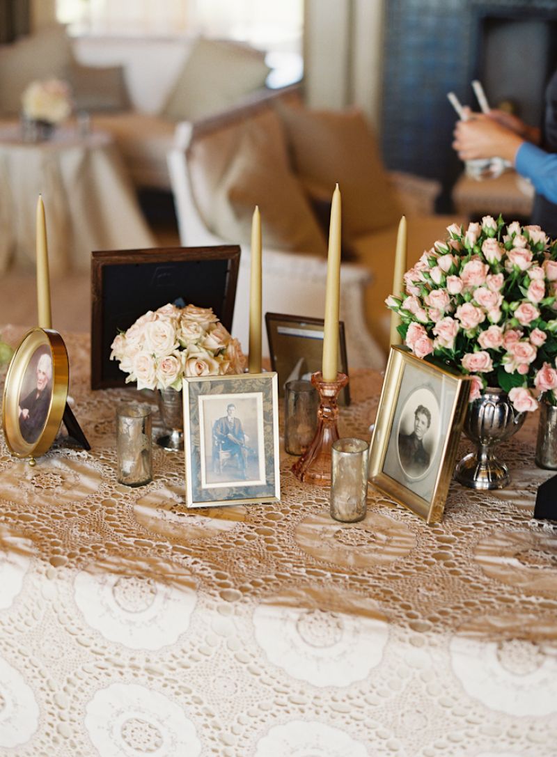IT’S ALL RELATIVE: For a personal touch, Crystal assembled old family photos to mix in with the taper candles and bunches of roses.