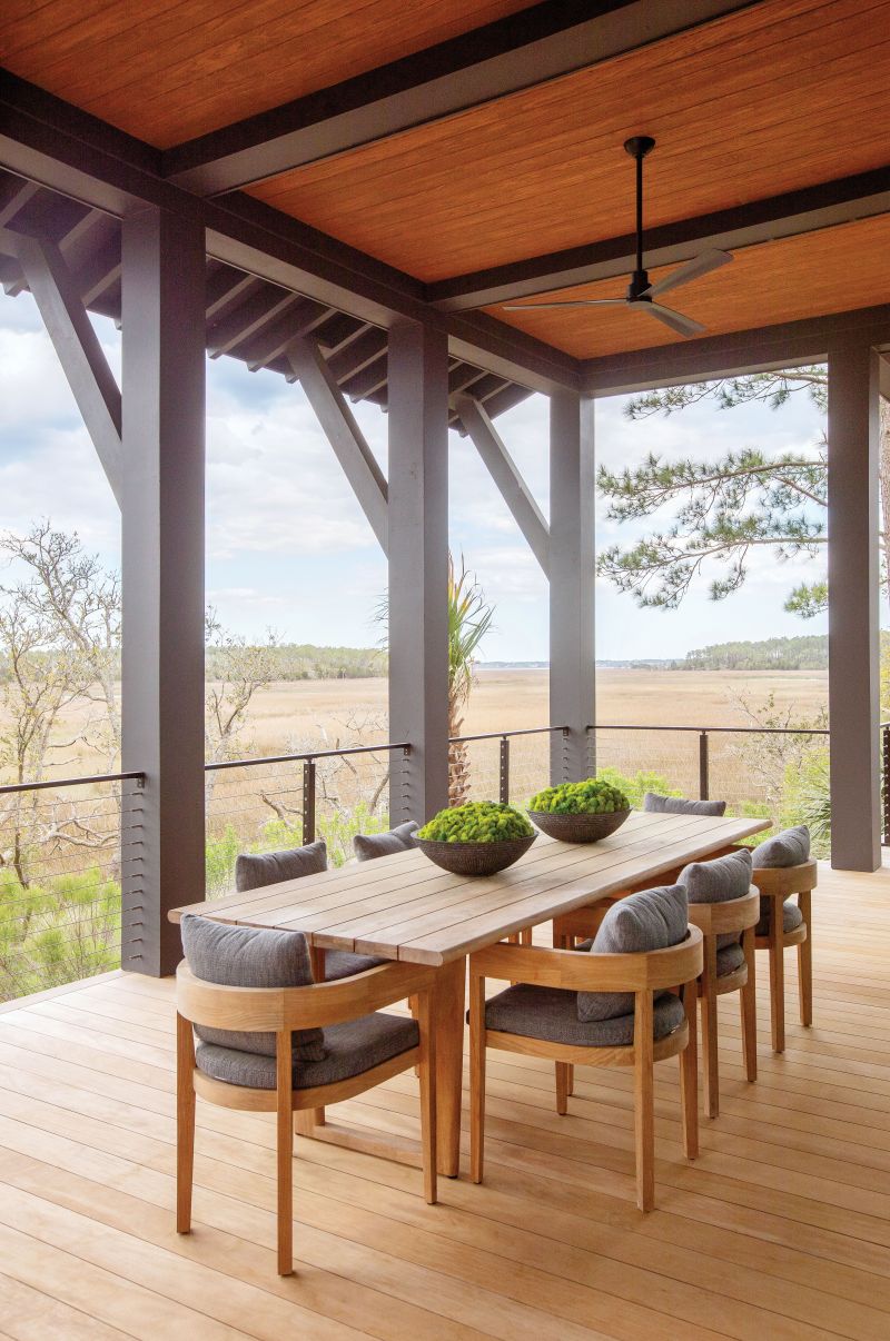 Blending In: The clean lines of the Balmain teak dining table and chairs from RH conform to this contemporary outdoor perch with views over Ralston Creek toward Mount Pleasant.