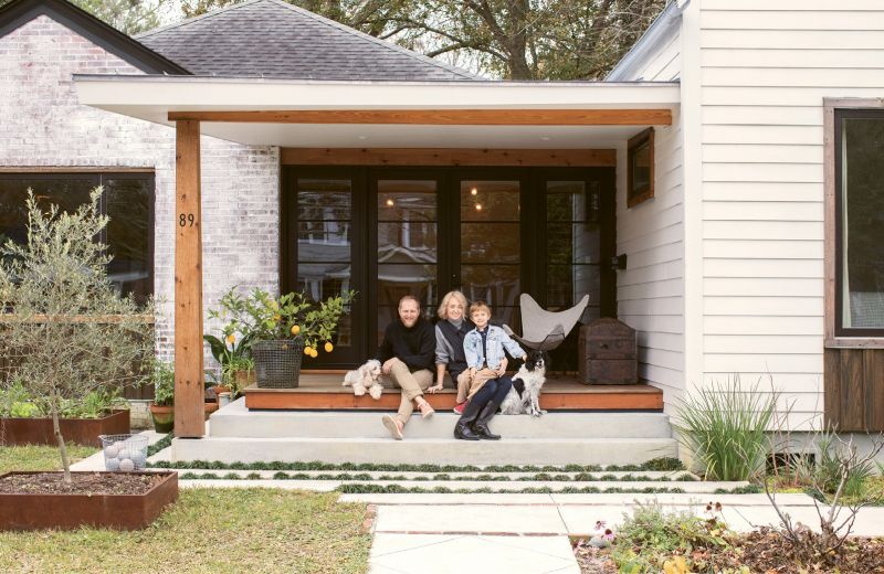 Jacques and Carrie Larson, pictured here with six-year-old son Jack and pups Lily Bean and Maggie Mayhem, hired Alicia Reed of Reggie Gibson Architects to help them transform their West Ashley cottage into a modern home perfect for the way their family lives and eats. Much of the landscape is devoted to edible plants, including an olive tree