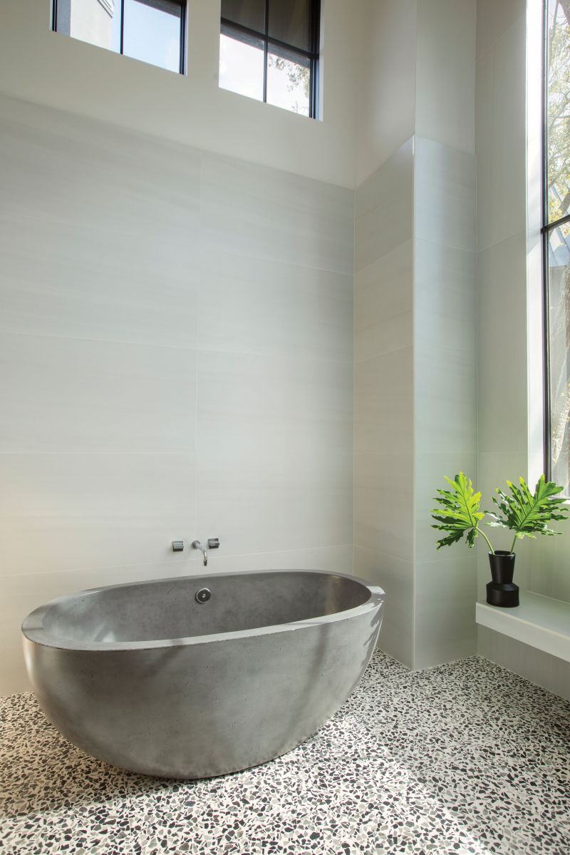 Spa Dreams: A concrete-and-glass terrazzo floor by Concrete Collaborative adds texture and interest to the large walk-in shower, with Native Trails “Avalon” freestanding cement soaking tub from Molufs.