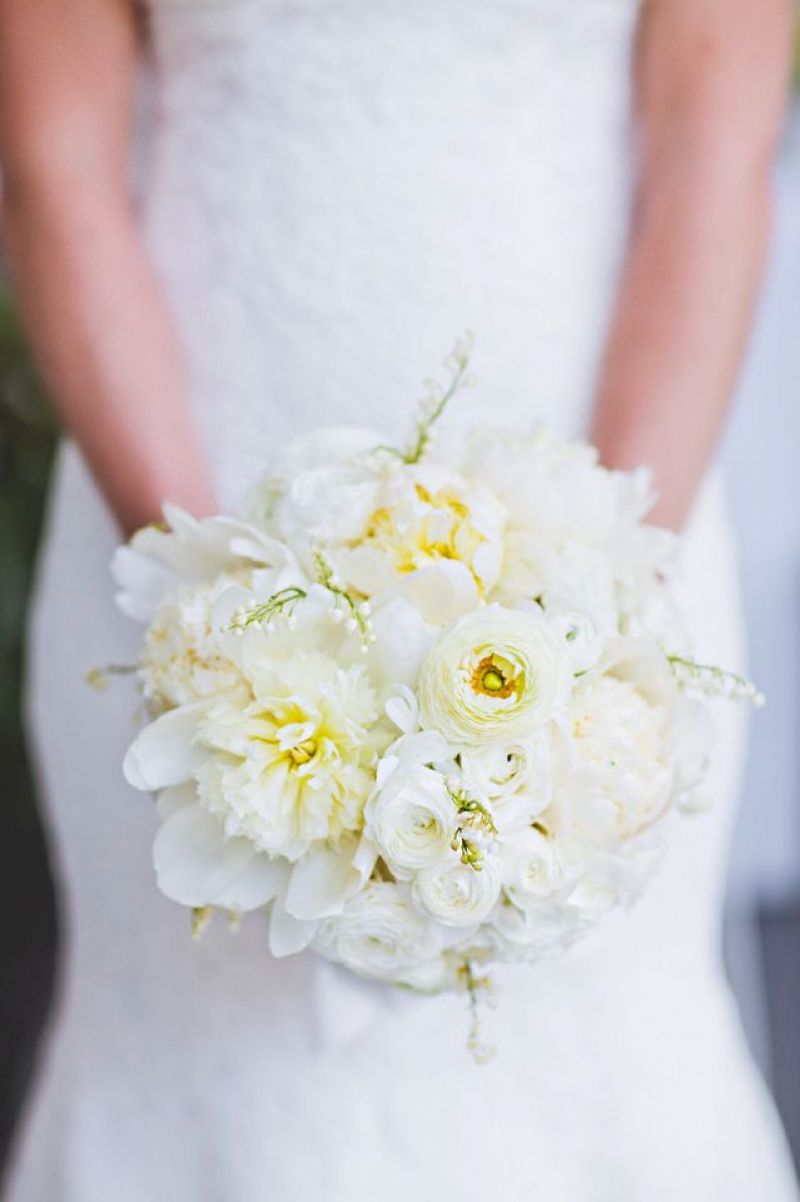 PALE PRETTIES: White peonies, roses, ranunculus, and Lily of the Valley filled the bridal bouquet.