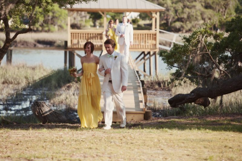 GRAND ENTRANCE: The wedding party led the procession from the dock to the altar.