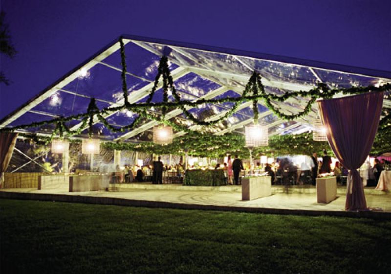 Pavilion Perfection:The dining hall was lined with rye grass planters sprouting with copper garden signs engraved with guest names and table numbers. The enormous metal drum shades were four feet in diameter and four feet tall.