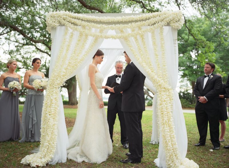WITH THIS RING: The couple exchanged vows beneath an altar of sheer fabric and fresh flower garlands. Sara’s uncle officiated the ceremony. “Even with no experience, we knew he would do an amazing job,” says Sara.