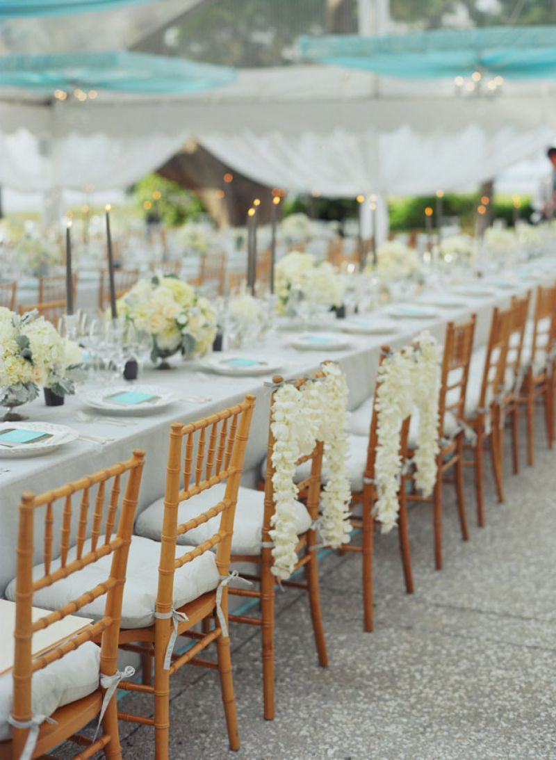 MAKE YOUR MARK: The bride and groom’s reception seats were designated by strings of flowers—the same garlands that adorned the ceremony’s altar.