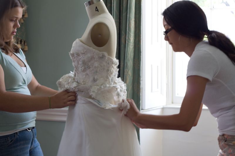 The mannequin was a size 4 and “Versailles” fit it like a glove, but still, Kristy needed a little help from Charleston Weddings editor Melissa Bigner to zip it up.