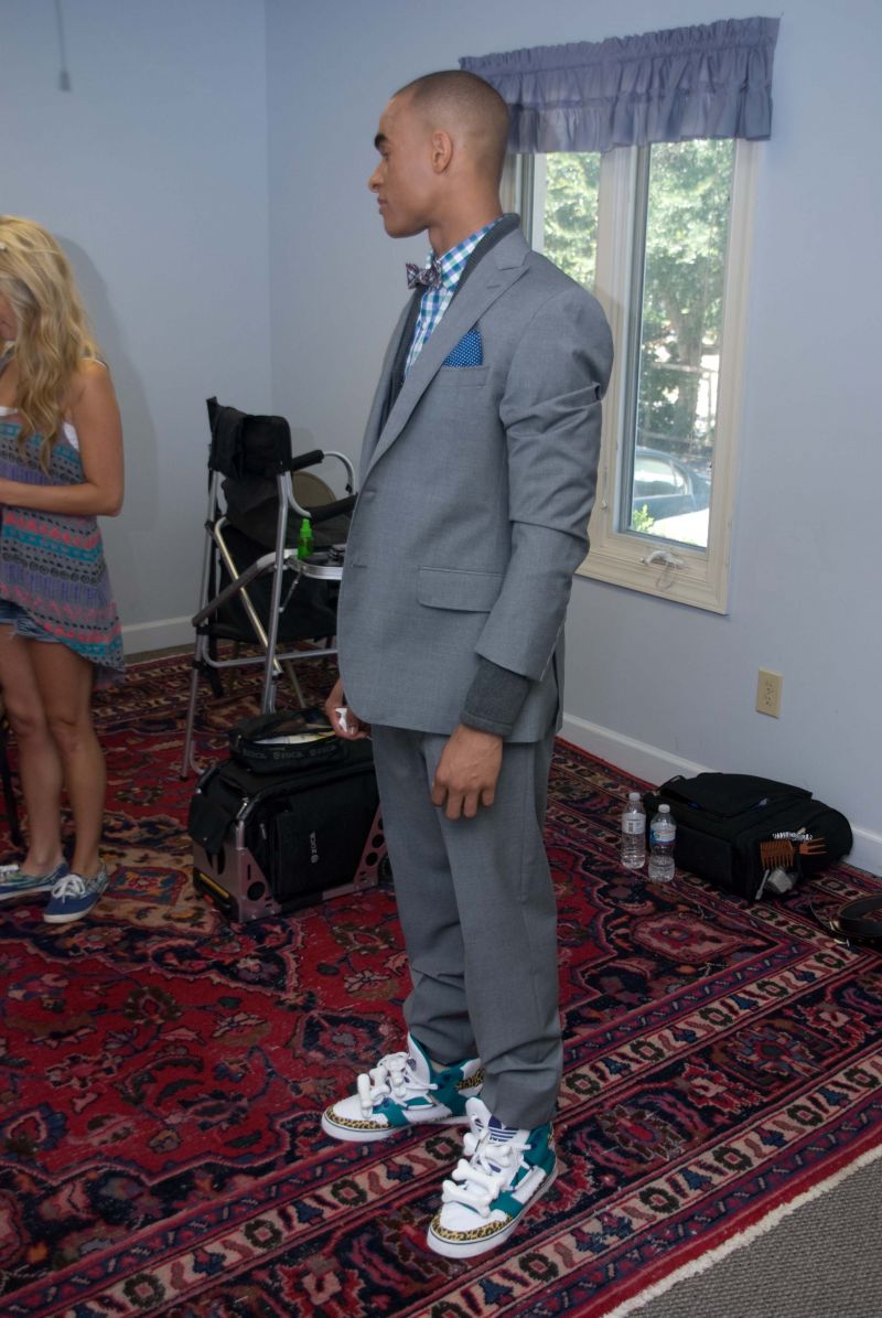 Caesar sports “JS Bones,” Jeremy Scott’s adidas Orginals—quite the statement shoes with his suit.