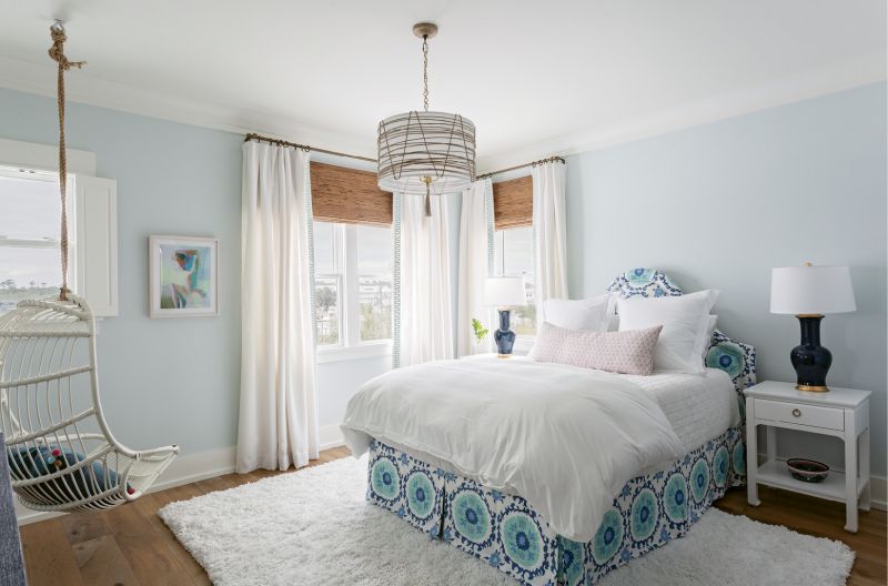 The McElveens’ youngest daughter’s bedroom boasts eye-catching fabrics, from the custom-made bench in the Galbraith &amp; Paul “Seville Tile” print in the master to the linen headboard with matching blue Quadrille bed skirt.