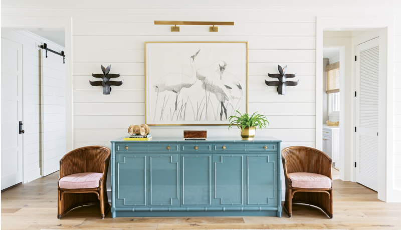 Perky Pastels: A custom-designed French blue credenza punctuates the McElveens’ expansive entryway. Two vintage chairs from Charleston’s Indigo Market and a Judith Vivell charcoal drawing, “Whopping Cranes in Reeds II,” finish off the vignette.