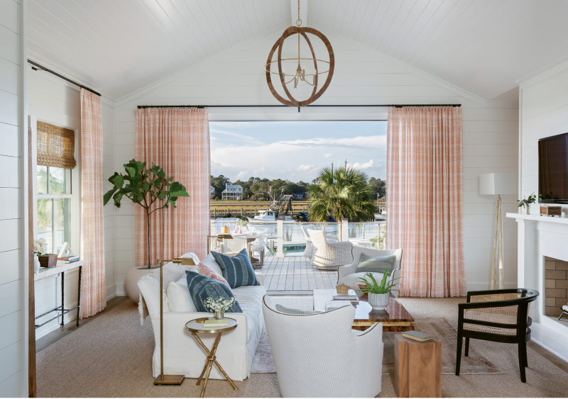 Calming hues repeat in the main sitting room, where tangerine linen curtains in a Rebecca Atwood print flutter through the breeze wafting in from Shem Creek.