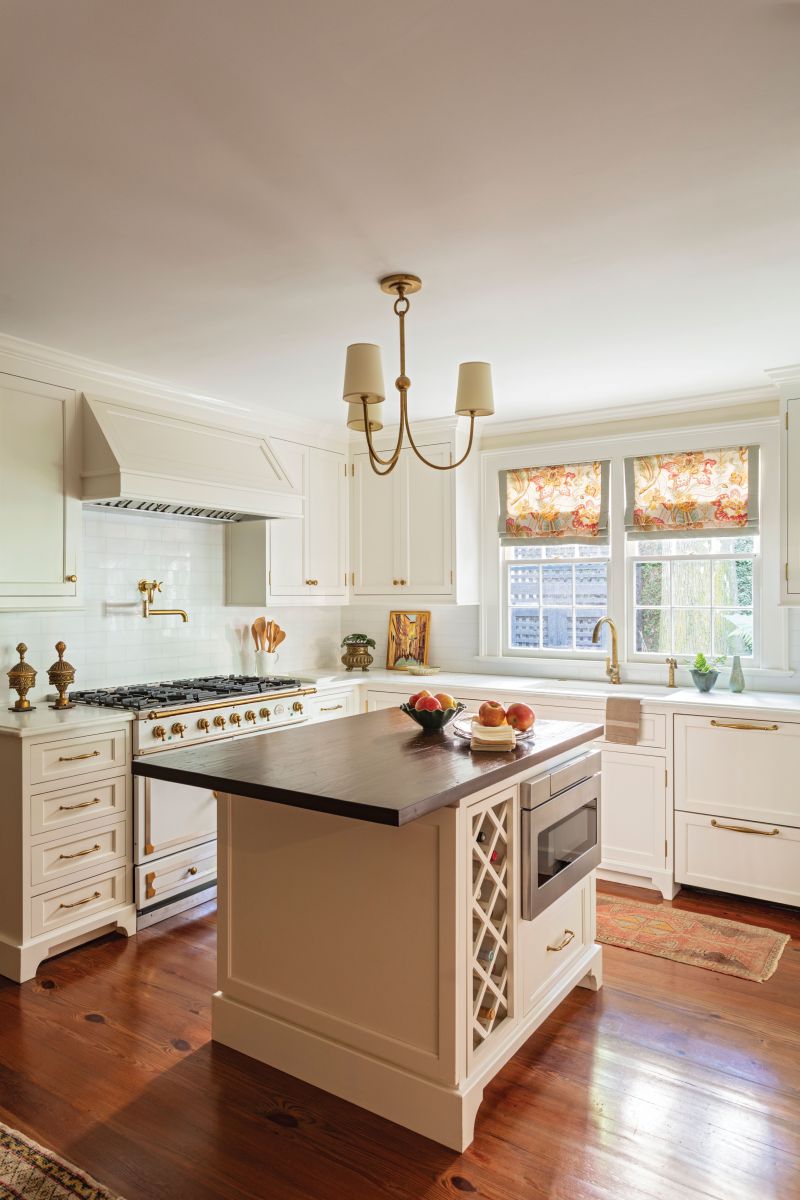 Light &amp; Bright: The kitchen, situated in the home’s hyphen, is painted in Benjamin Moore “White Dove” and boasts a La Cornue range.