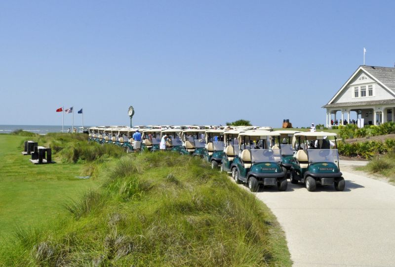 Golf carts lined up to transport golfers throughout the course.