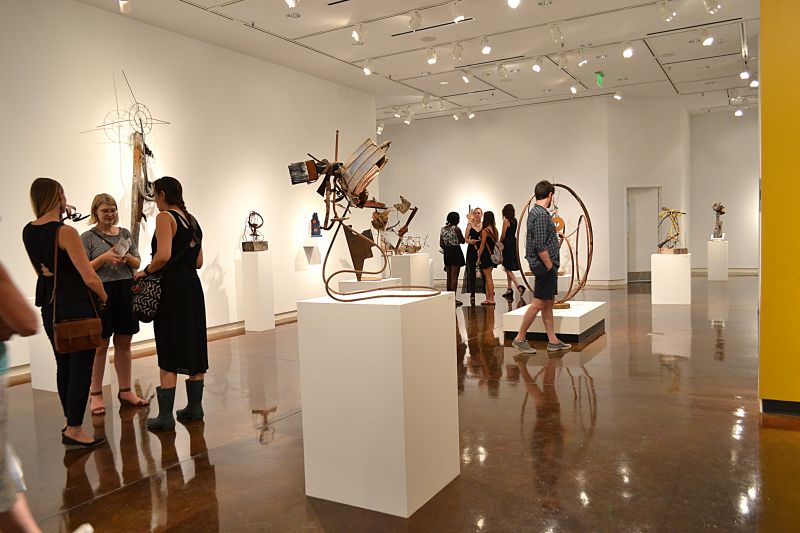 Guests gathered in the gallery to chat and gaze at the collection of rustic sculptures.