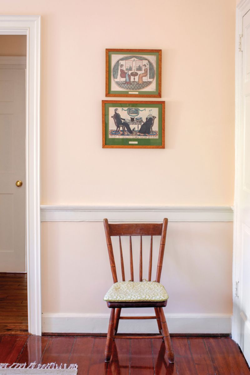 Vintage prints depicting couples enjoying tea add to the whimsical feel of this room.