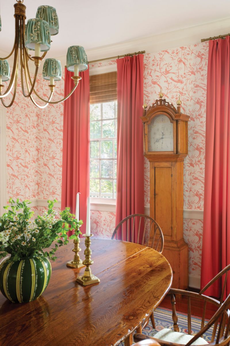 A playful rug from L.L.Bean adds a touch of modern style to the space, along with the deep pink drapes flanking the family’s heirloom grandfather clock.