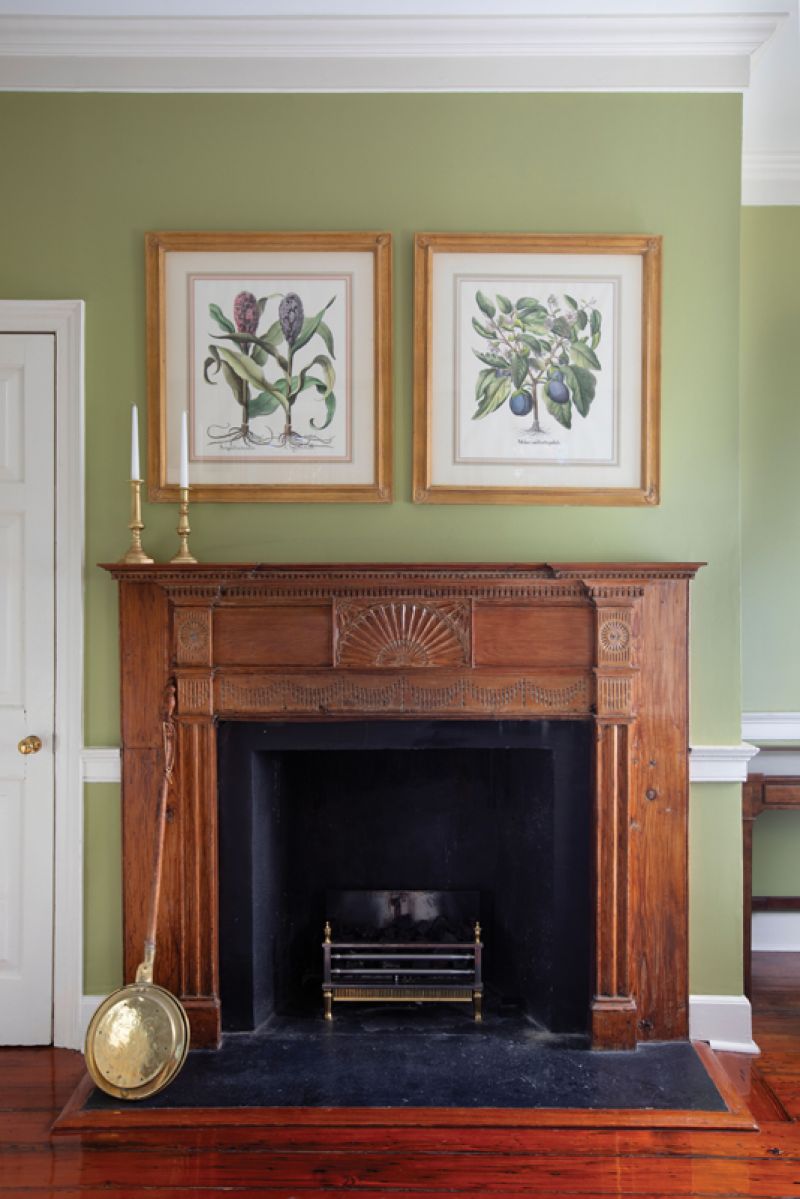 Here, another original hand-carved mantelpiece takes center stage, complemented by Benjamin Moore “Brookside Moss” paint.