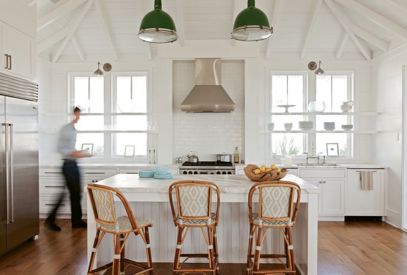 Bright Ideas: Keenan refashioned two old gymnasium lights, hung by a whipped rope cord, as kitchen pendants, adding a pop of color to the mostly white space.