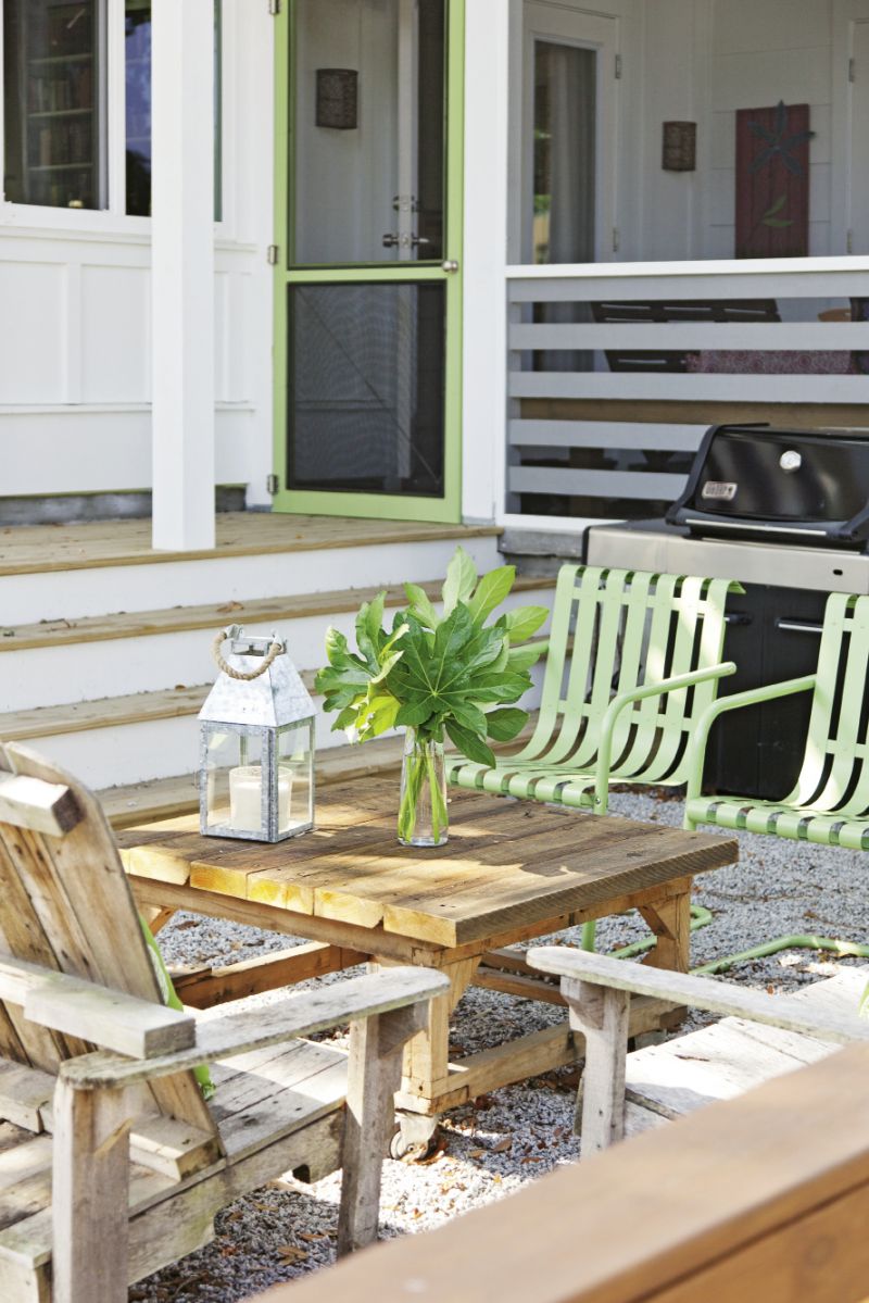 Cheerful green patio chairs and Adirondacks made from salvaged pallets warm up the home’s modern exterior.