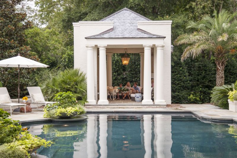 CABANA COOL: Elevated pool cabanas provide shade and a place to relax (top). A landscaped brick wall acts as a privacy screen as the Hastings boys face off in the pool for a game of chicken.