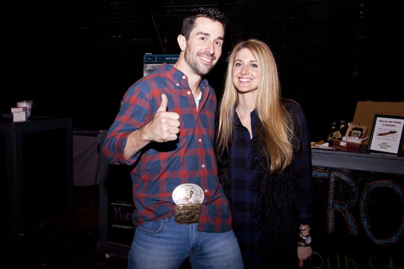 Joel Gardener, the winner of the bull riding contest, showing off his hard-earned belt buckle prize with Toni Picciotto