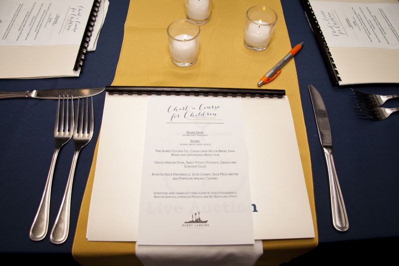 Each table setting included a live auction directory and a dinner menu.