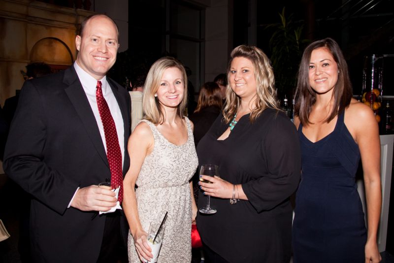 Shane and Jennifer Woolf, Jennifer Philp, and Courtenay Speir enjoyed drinks by the bar.