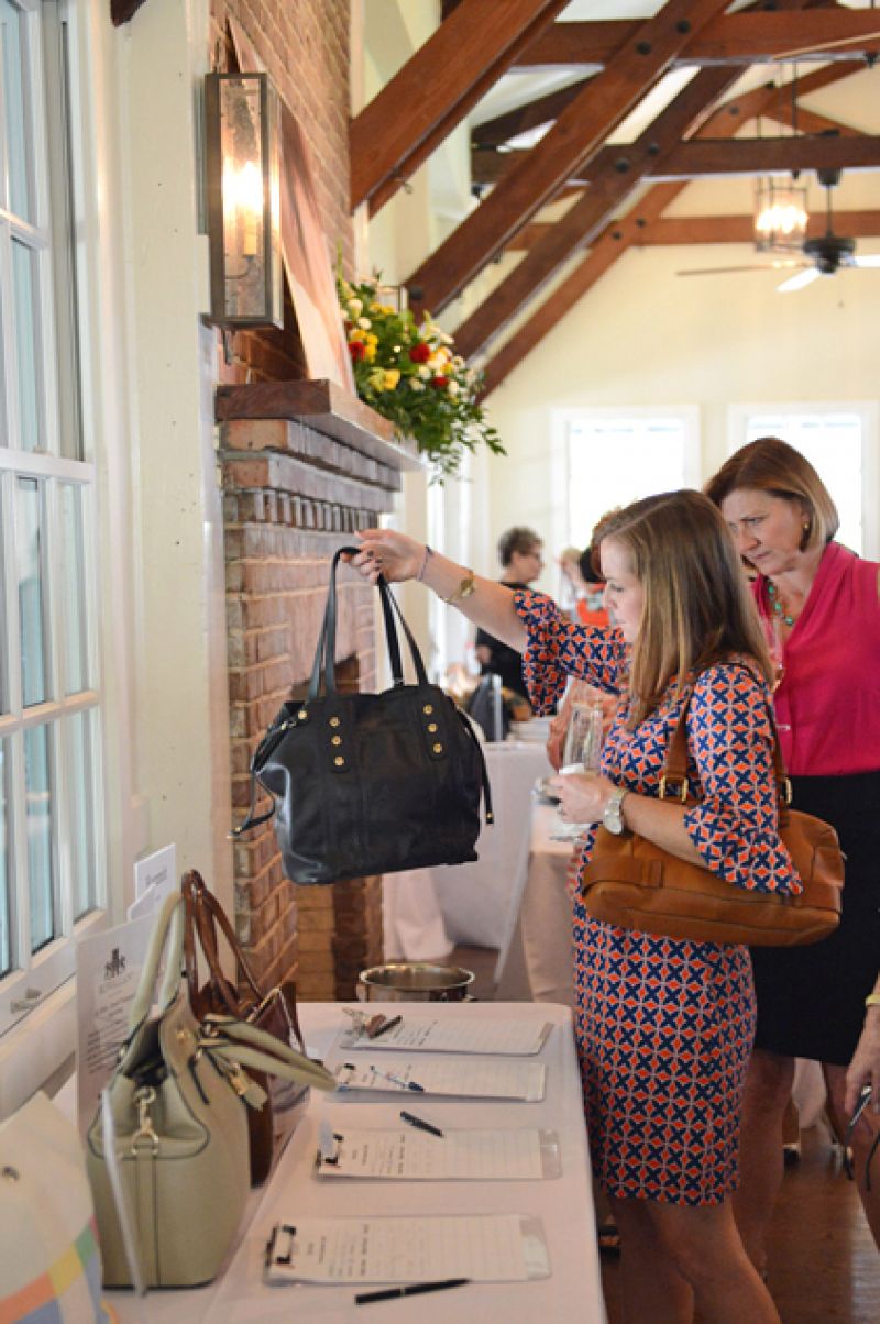Before lunch, ladies went around the room bidding on their favorite bags.