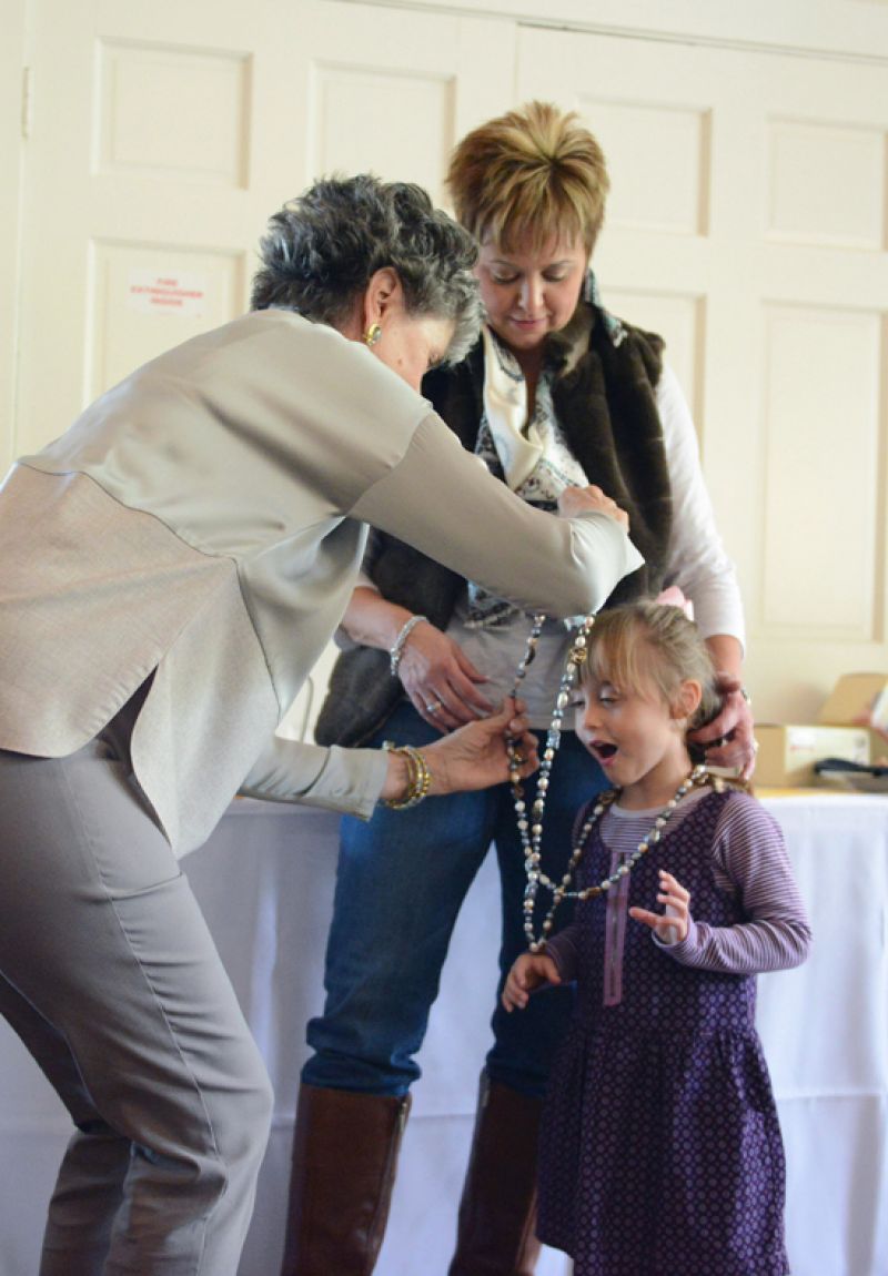 Judy Casey adorned former MUSC patient McKenzie Evans in a fashionable necklace.
