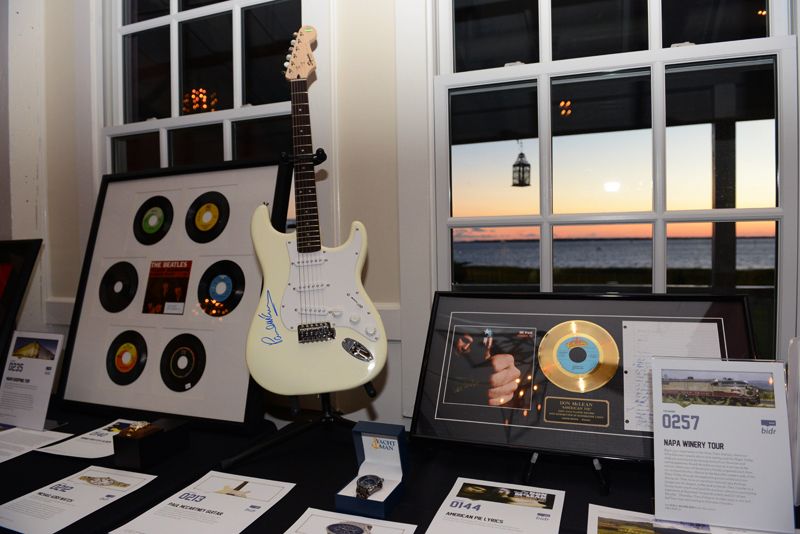 Auction items included signed albums and a guitar with Paul McCartney’s autograph.