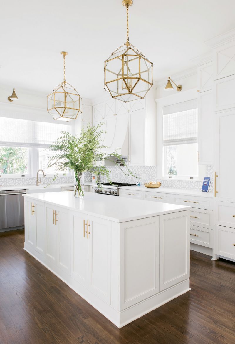 LIGHT &amp; BRIGHT: “The kitchen is a good example of what Melissa did so well, filling every nook and cranny and making them useful in some way,” says Alison. Fireclay backsplash and gold pendants and sconces add glamour to the utilitarian space.