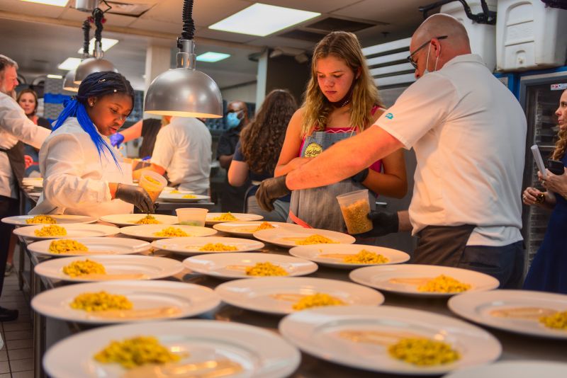Little chefs Journee Myers and Claudia Hassell plate street corn.