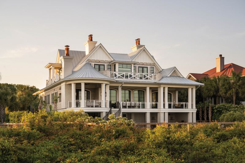 Hamptons in the House: Herlong Architecture &amp; Interiors designed the shingle-style beachfront house on Isle of Palms. Featuring a classic Hamptons look, with a whimsical roofline, turrets, and rotundas, the 5,000-square-foot home provides plenty of space and grandeur for the homeowner’s art and antique collections, while maintaining a casual coastal vibe.