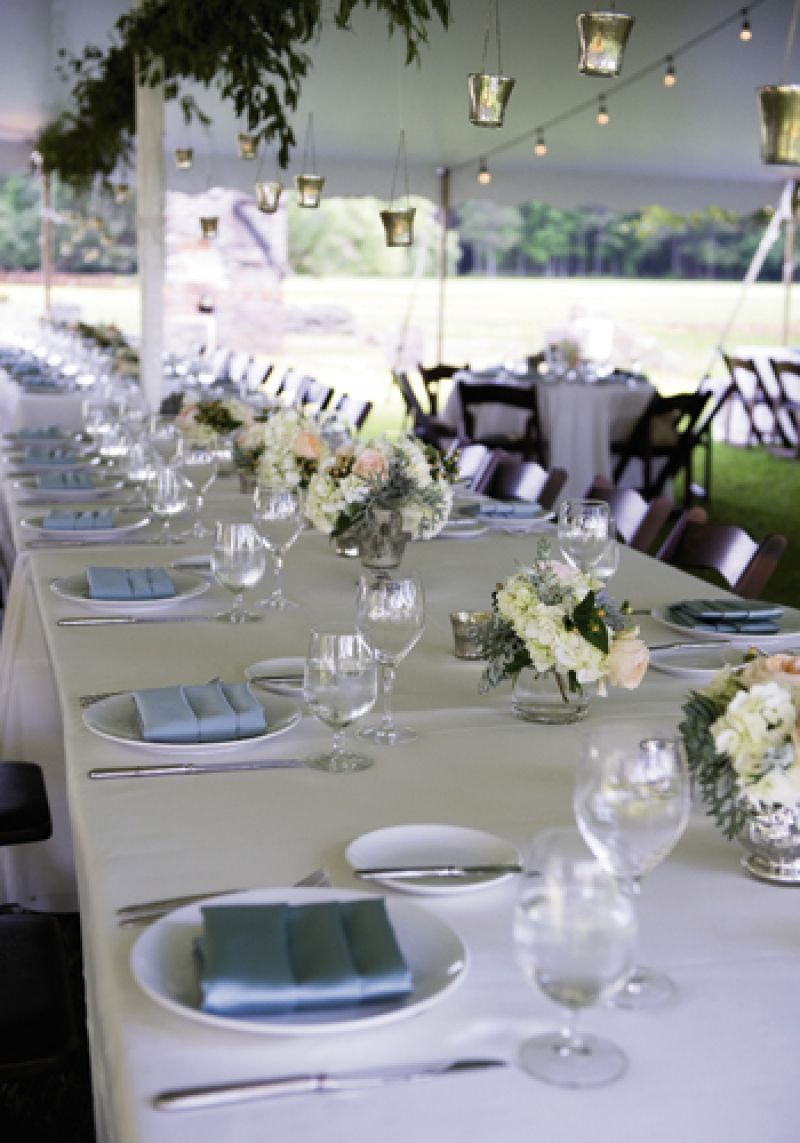DIVE IN: Ivory tablecloths from BBJ Linen,  silver-blue napkins, and mercury glass gave the sit-down Southern supper a sense of casual elegance.
