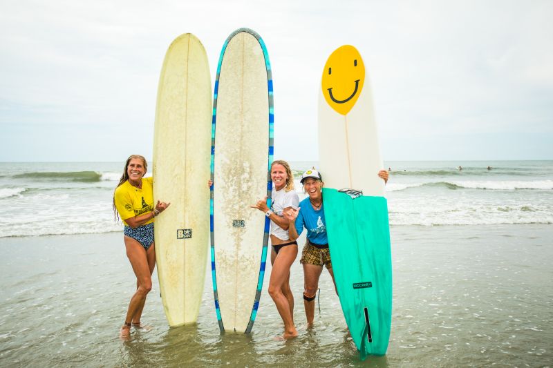 Tara Novit, Jenny Brown, and Marty Mentzer pose for a photo during the Folly Beach Wahine Classic.