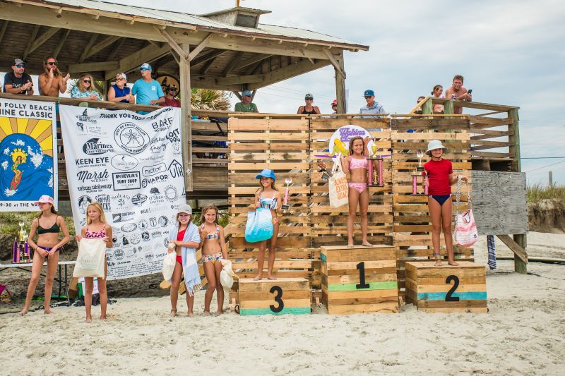 Menehune Shortboard winners Adleigh Honeycutt, Kallady Youngblood,  and Summer Ciello receive trophies during the Folly Beach Wahine Classic.