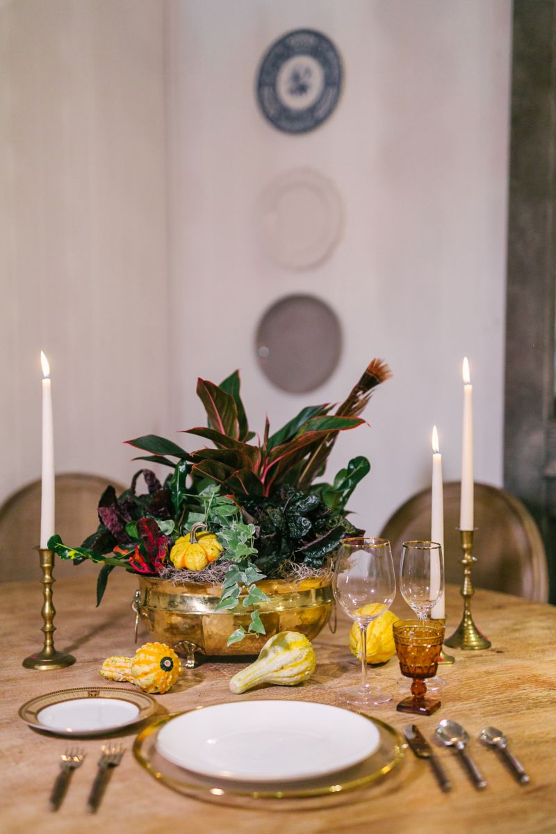Place the finished arrangement at the center of a round table, scattering mini mini gourds and squash around it. Pillar candles add elegance; if you’re going for a less-formal look, votives will be spot-on.