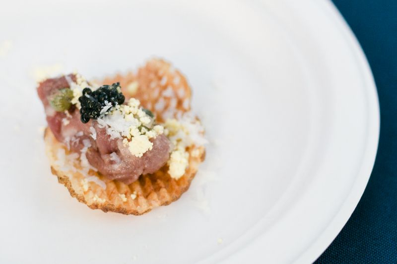 This decadent small bite from Tradd&#039;s features beef tartare and caviar, balanced on top of a crisp potato chip.