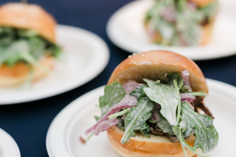 Grill 225&#039;s sliders were piled high with prime beef, pickled red onion, baby arugula, and topped with horseradish aioli.