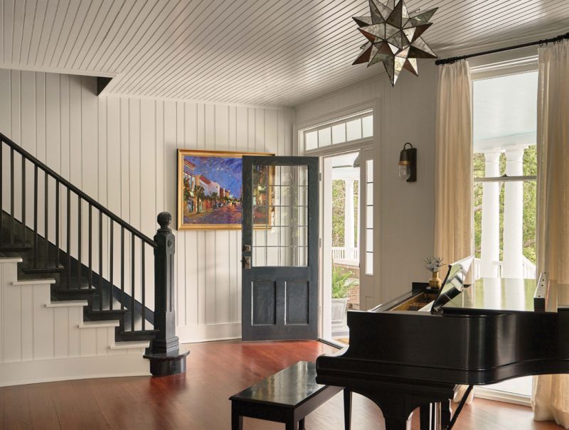 The flooring, wainscoting, stairway, front door, and windows are all original.